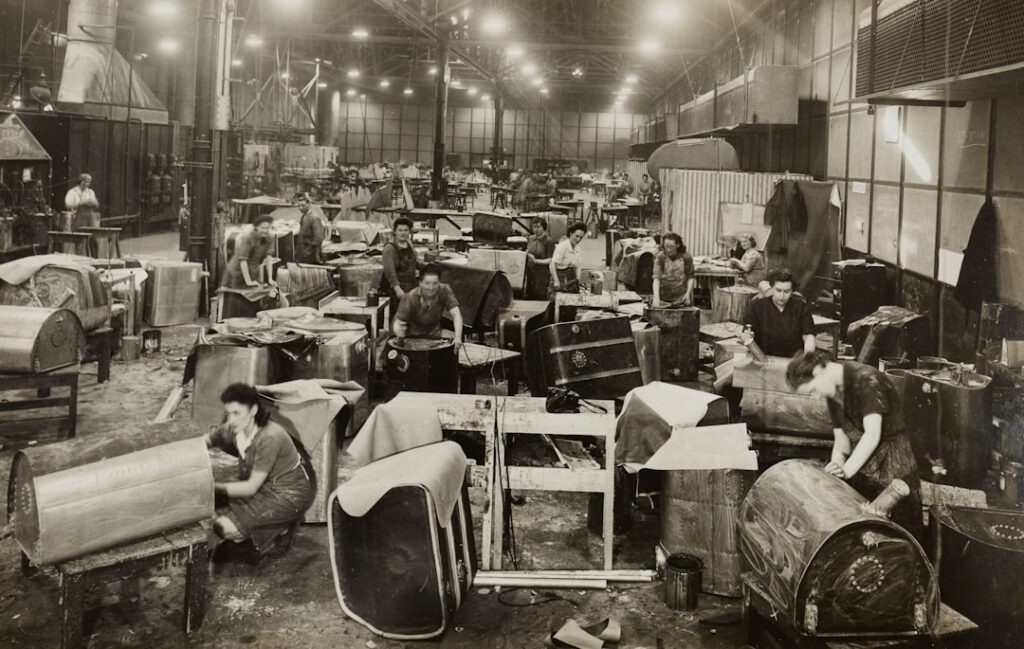 grayscale photo of people sitting on chair