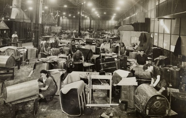 grayscale photo of people sitting on chair