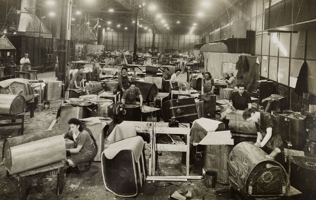grayscale photo of people sitting on chair